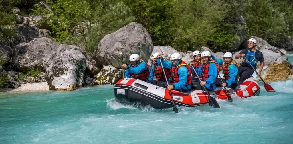 Grupo haciendo actividad de aventura y rafting en equipo en Galicia
